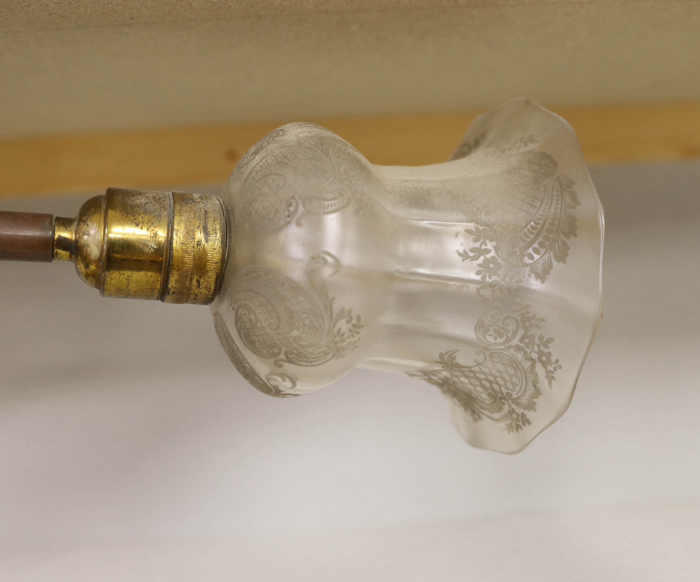 Two early 20th century brass reading lamps with Bakelite and etched opaque glass shades, the largest 54cm high